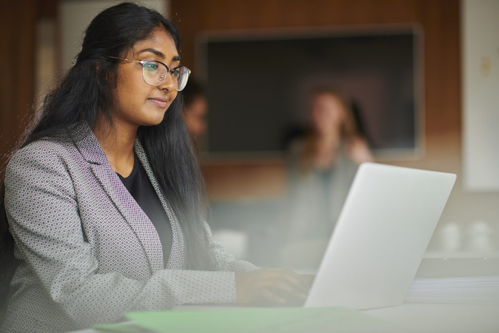 Summer student using a laptop at a law firm