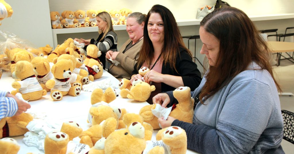 Harrison Pensa Personal Injury staff dress over 400 teddy bears for the Magical Winter Ball.