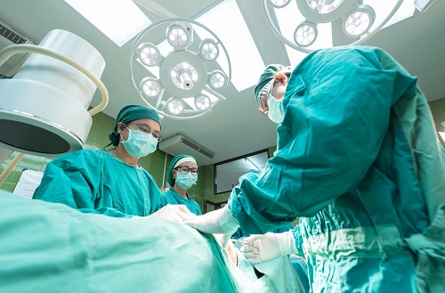 Image of a team of surgeons operating in an operating room